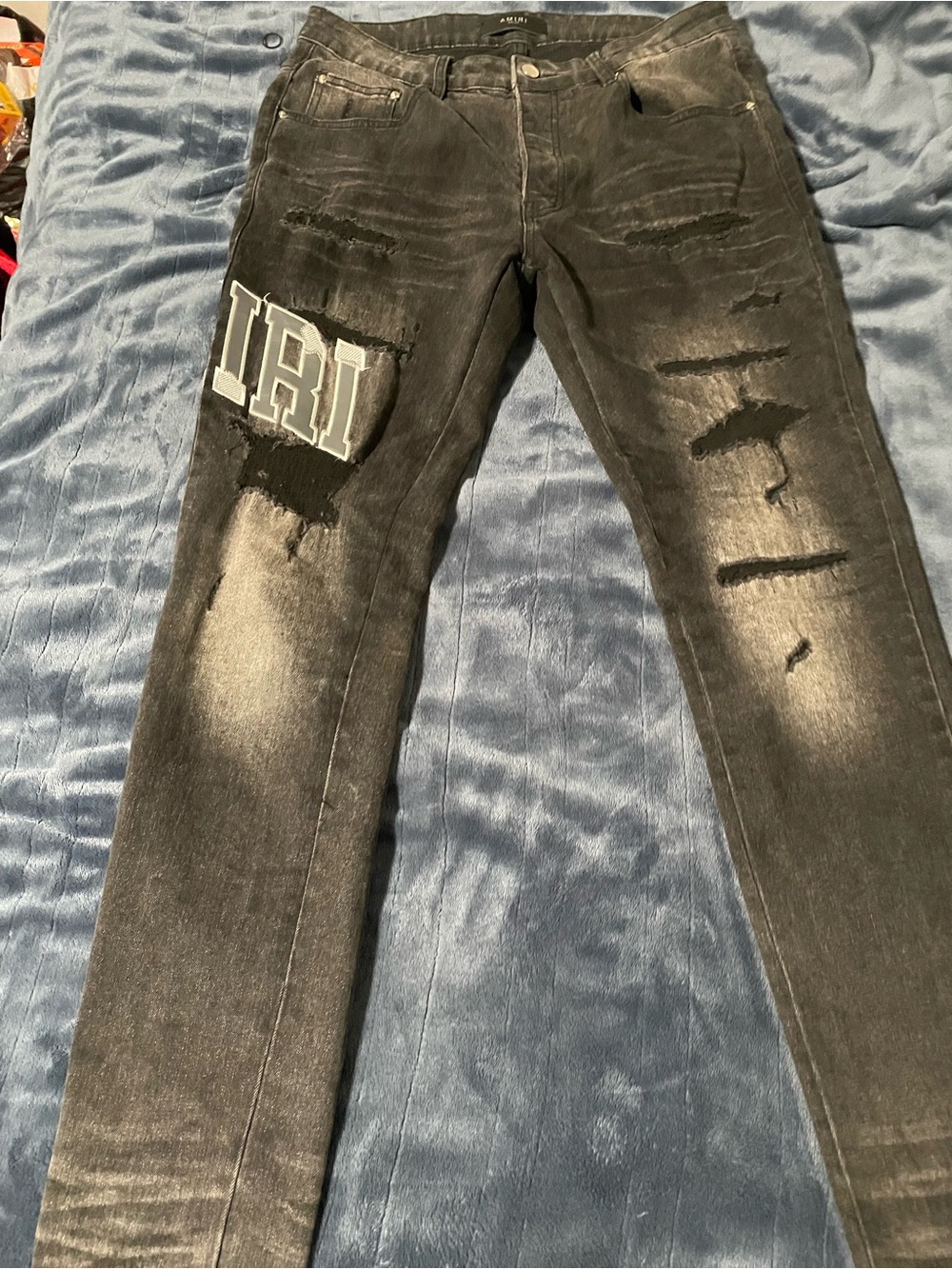 AMIRI Distressed Black Skinny Jeans with Patch